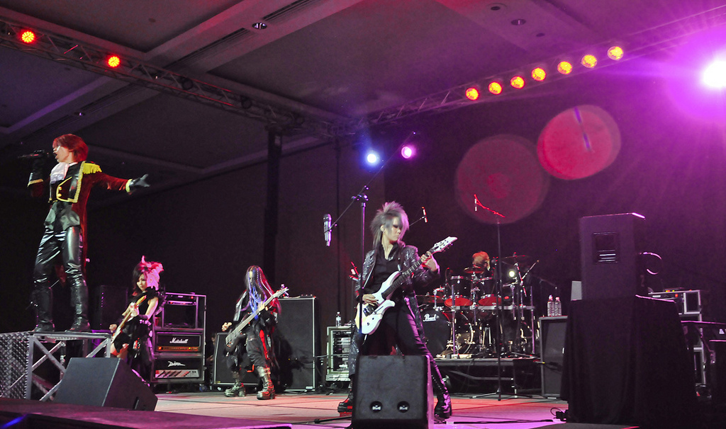 Japanese rock band Exist Trace performing at an anime convention