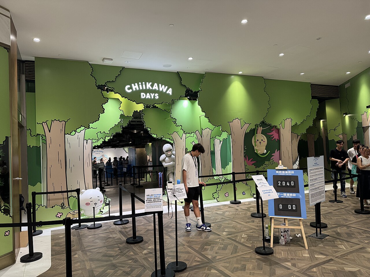 Entrance to a "Chiikawa Days" pop-up exhibition in a shopping mall, with a queue of visitors