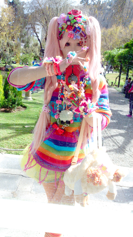 Decora fashion in bright rainbow colors, layered with plastic hair clips, beaded jewelry, and toy accessories