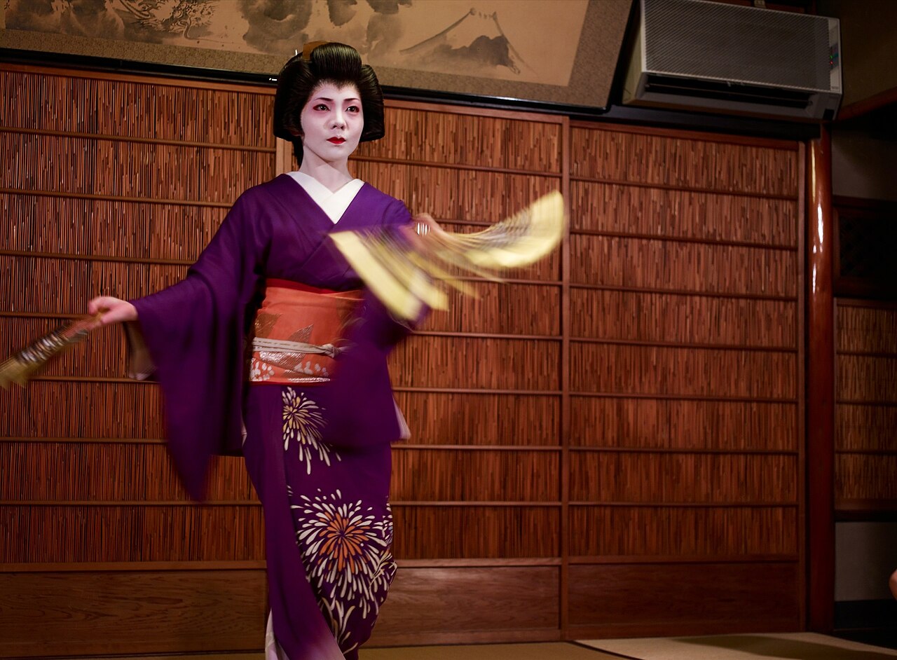 A geisha performing a fan dance in Gion, Kyoto