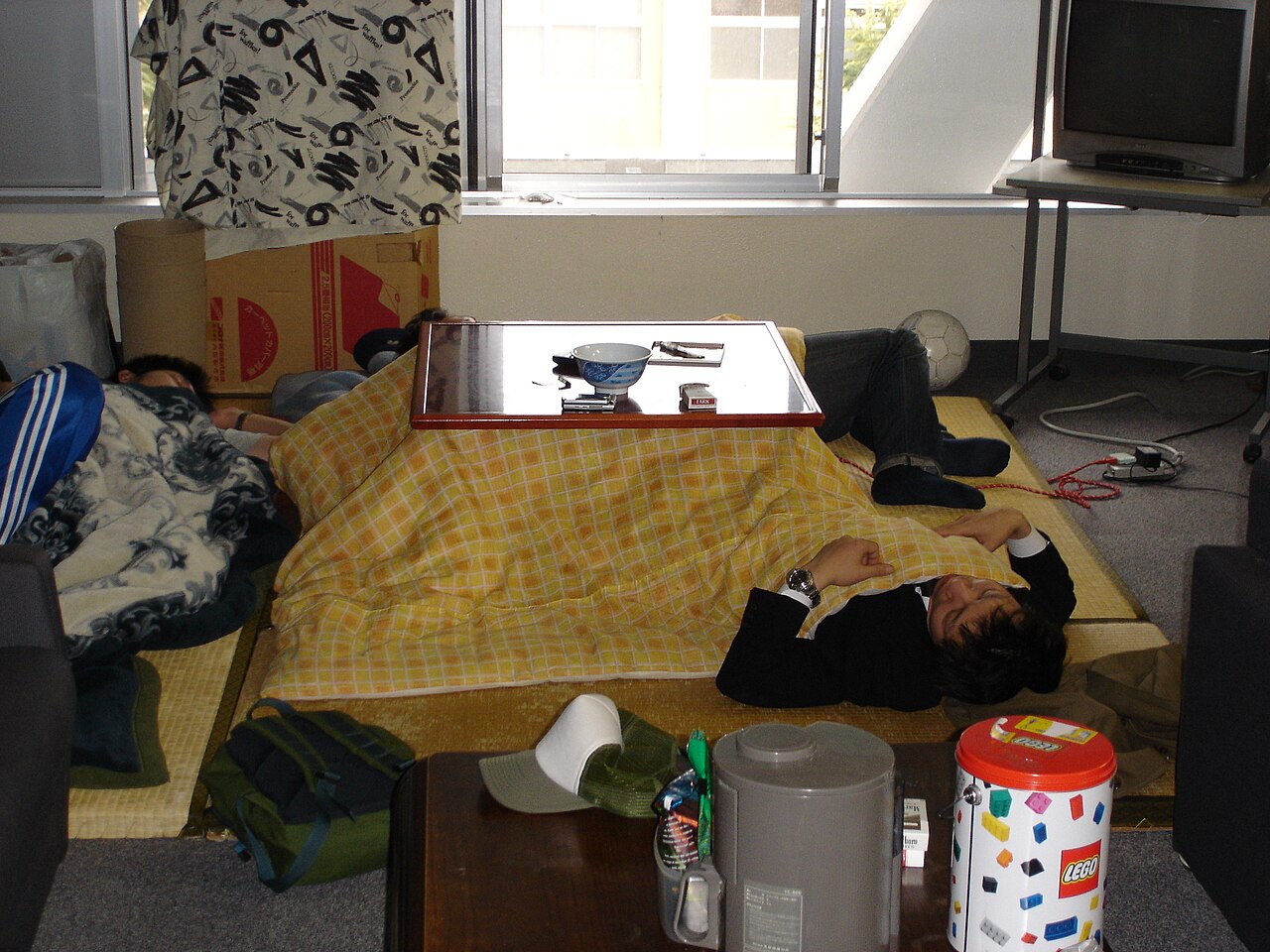 A modern kotatsu with its thick blanket in a Japanese home