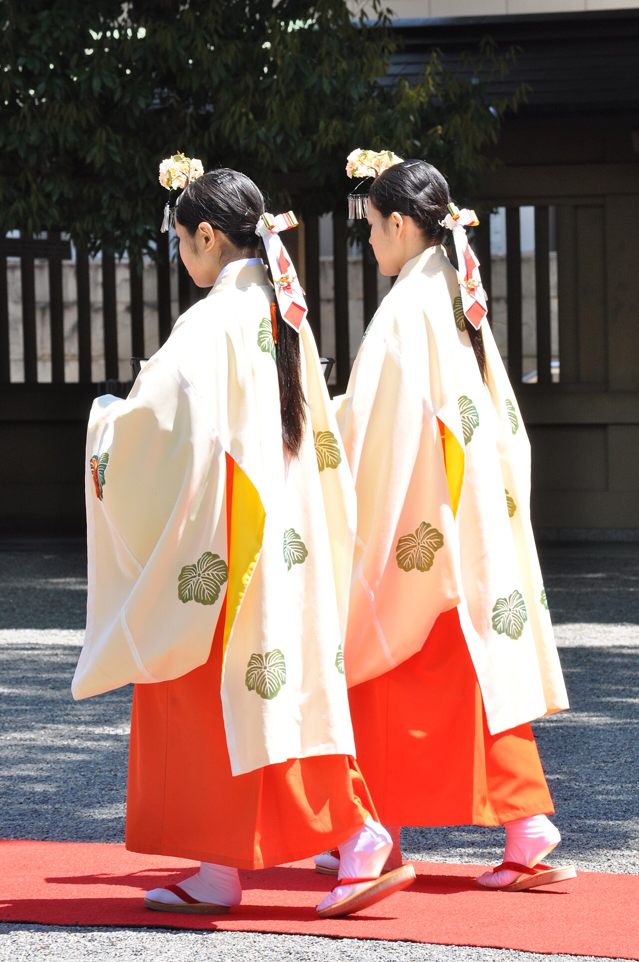A miko wearing the traditional white kosode and red hakama, dressed for kagura sacred dance
