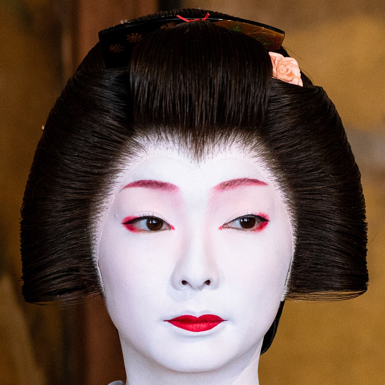 Kyoto geiko wearing traditional white oshiroi makeup and a kimono