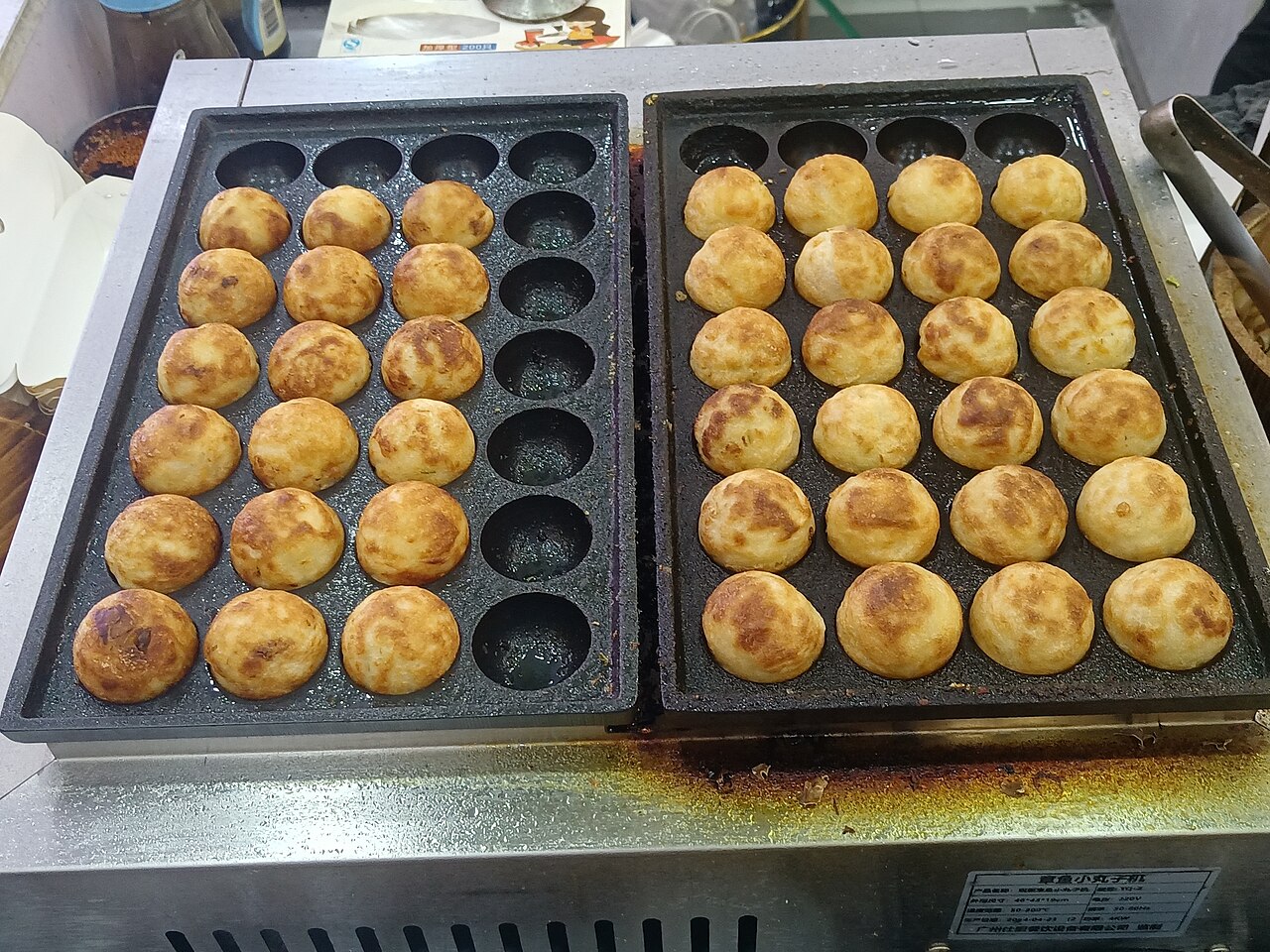 Takoyaki balls topped with sauce, mayonnaise, bonito flakes, and aonori