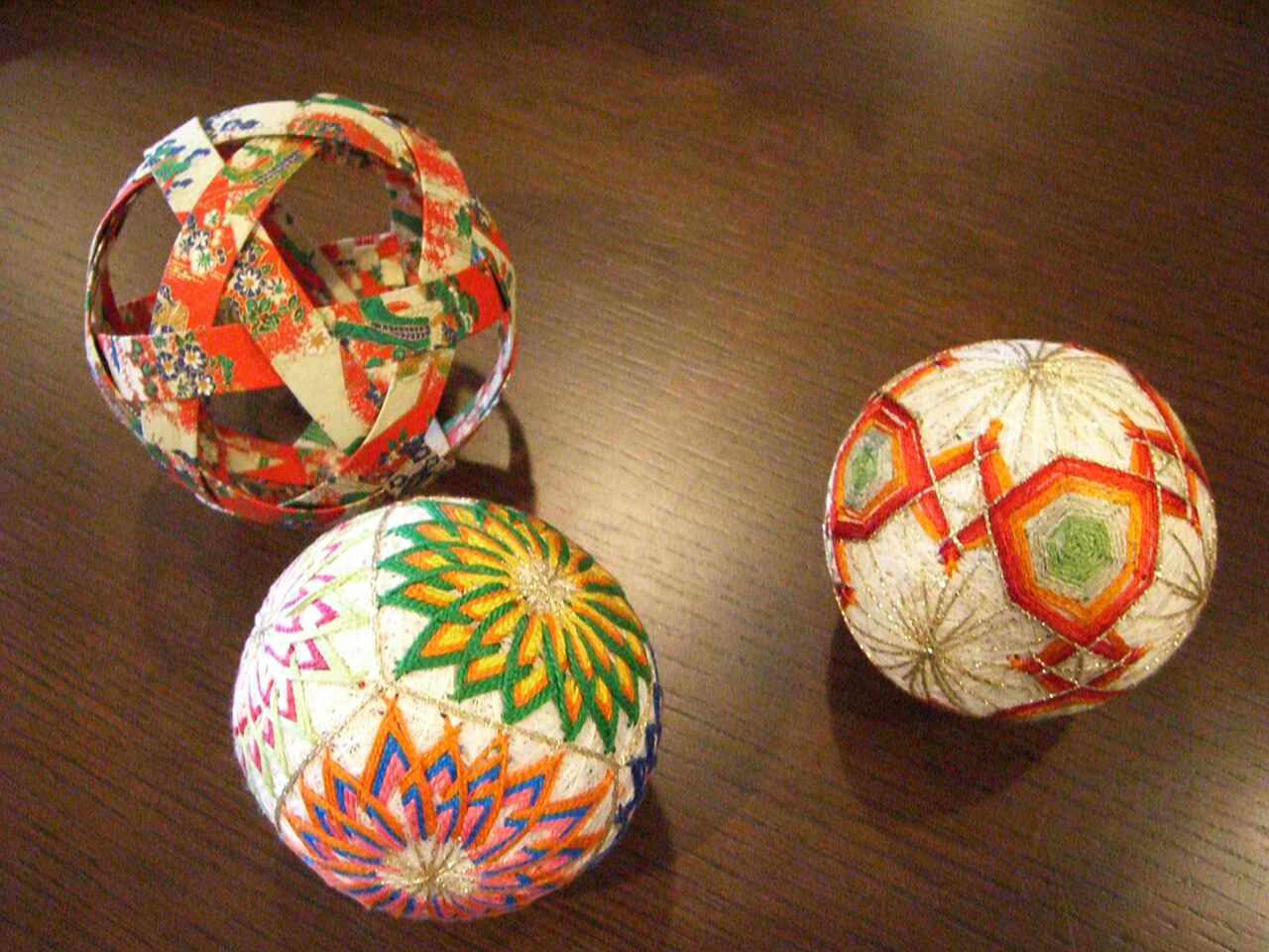 Colorful embroidered temari balls displaying geometric thread patterns